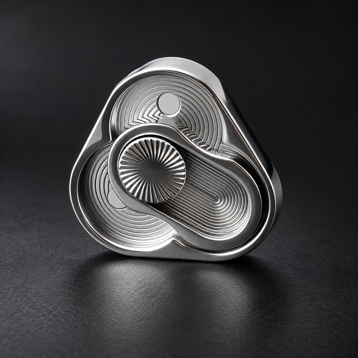 Silver LHAPTIC TriArc Magnetic Slider on a dark textured surface